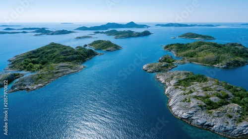 Aerial view of serene blue waters surrounding lush green islands under a clear sky, showcasing the beauty of summer vacation destinations in a coastal region