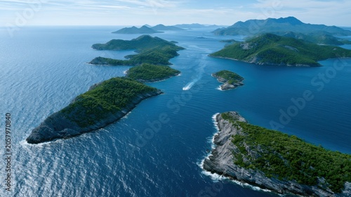 Aerial view of lush green islands surrounded by clear blue waters under a bright sky, showcasing a serene summer vacation destination in a tropical region
