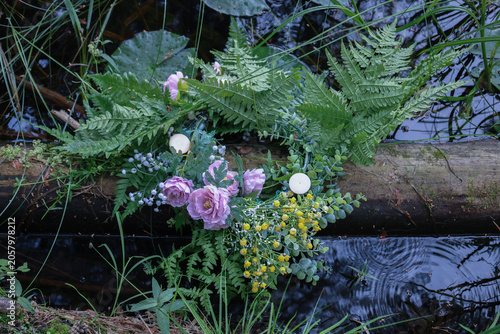 Burning candles on flower wreath floating in water, water, sacred, Ivan Kupala ritual pagan Slavic tradition