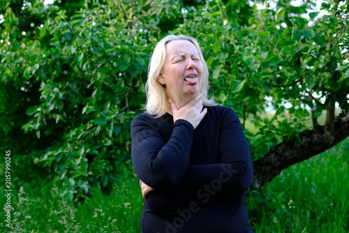 Tableau sur toile A visible reaction to irritation prompts her to touch the neck area and examine symptoms
