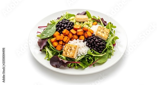 Colorful salad with grilled chicken, avocado, and cherry tomatoes on white plate healthy food