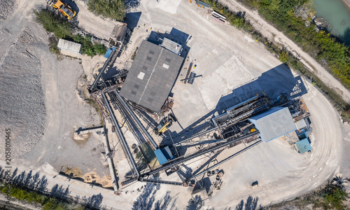 Top down aerial view of aggregate processing plant with conveyor systems and industrial infrastructure in Southern France