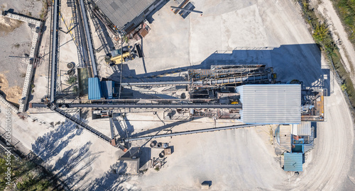 Top down aerial view of aggregate processing plant with conveyor systems and industrial infrastructure in Southern France