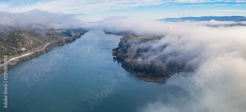 Aerial view of the Rhone River disappearing into morning fog in the Rhône Valley, Southern France
