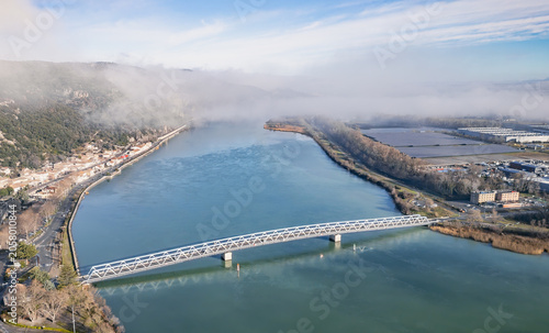 Aerial view of metal bridge crossing the Rhone River in Le Pouzin on a misty winter morning, Ardèche, France