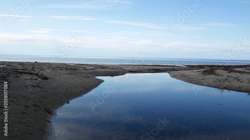 The Calm Waters of a Lake Connect with a Stream to Reach the St. Lawrence River at Sunset in Grand Makasti, Anticosti Island, Quebec, Canada
