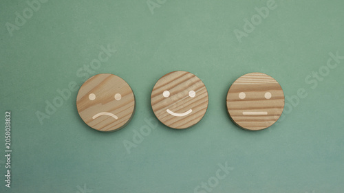 Wooden Mood Tokens Showing Sad, Happy And Neutral Faces For Feedback And Emotion Rating