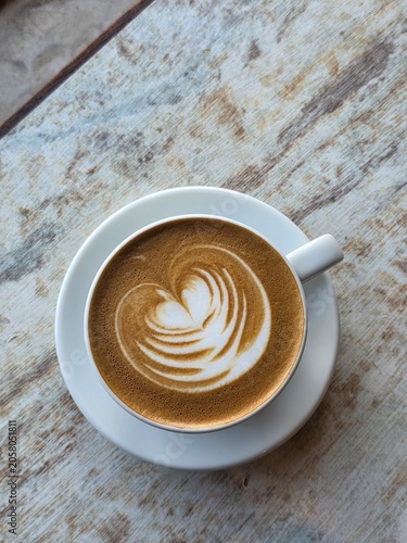 Top-down View of a Cup of Cafe Latte with Beautiful Heart Latte Art on a Vintage Wooden Table Background