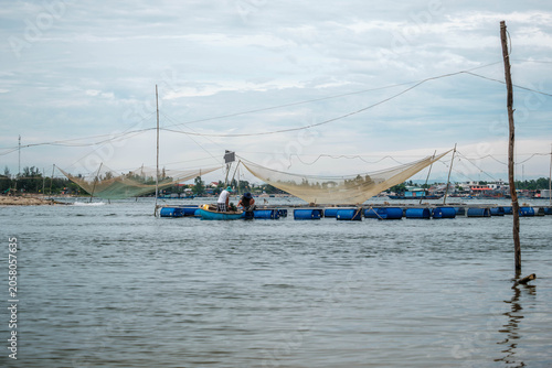 Vietnamese Fishermen Working at River Fish Farm