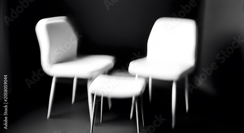 Blurred chairs in a dark room with a minimalist aesthetic and soft lighting