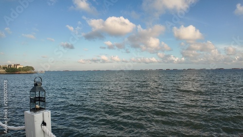 Photo of a seaside or beach view with blue sky and surrounding buildings