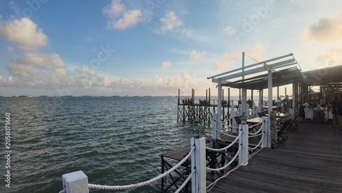 Photo of a seaside or beach view with blue sky and surrounding buildings