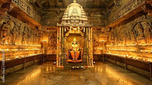 Ancient stone temple interior with golden Buddha statue.