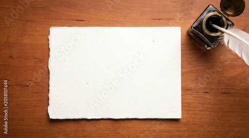 Blank Handmade Paper Sheet With Quill Pen On Polished Wooden Desk
