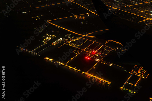 Night view Airplane Window of Shanghai, China Aerial Cityscape Above the Clouds