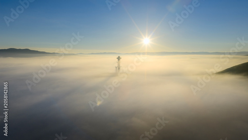 Принти на полотні Quiet plateau scenery of viewing tower on hilltop amid sea of fog during sunrise