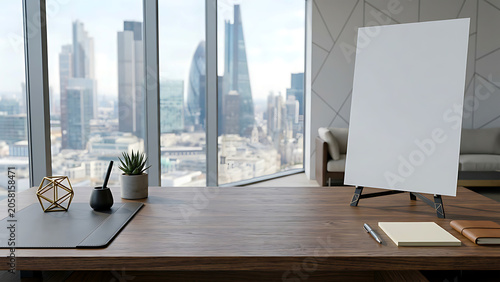Modern office desk with city skyline view, a blank canvas easel, and minimalist decor.