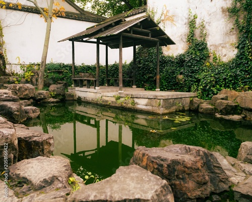 Green China pond landscape with resting area
