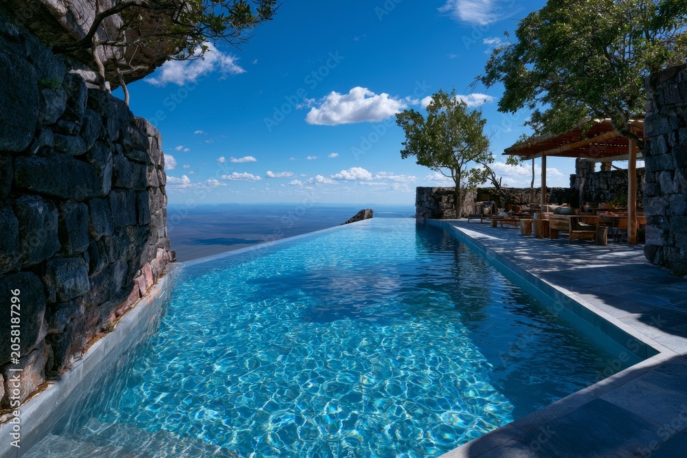 Fototapeta premium Infinity Pool Overlooking the Calm Blue Sea Under Clear Sky