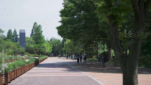 People enjoying a peaceful afternoon stroll and jogging in Seoul Olympic Park, South Korea
