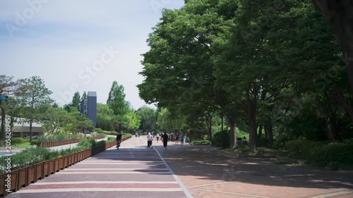 People enjoying a peaceful afternoon stroll and jogging in Seoul Olympic Park, South Korea