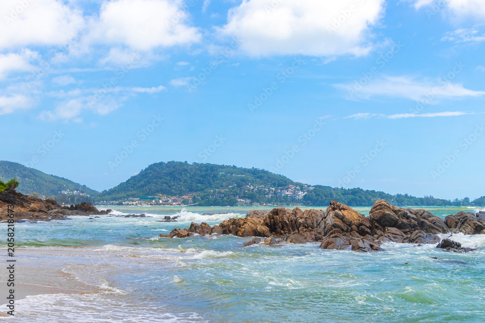 Obraz premium Sun turquoise clear water strong waves rocks tropical blue sky Thailand.