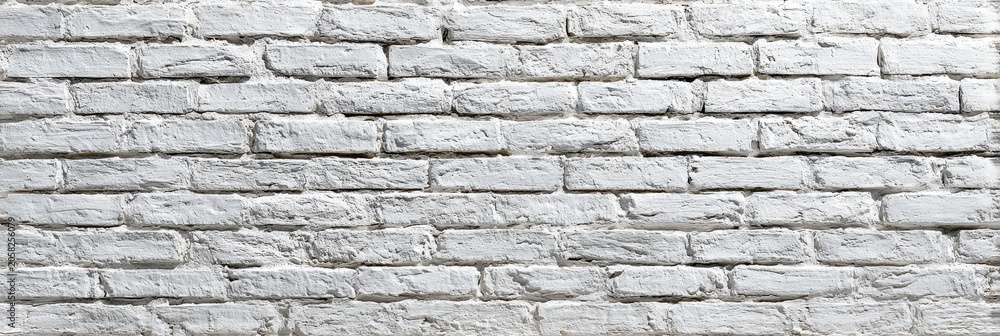 Fototapeta premium Textured white brick wall, a common background for diverse artistic applications