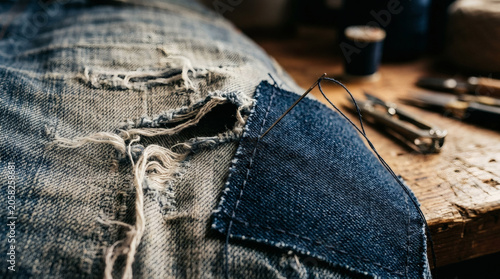 Distressed denim repair close up