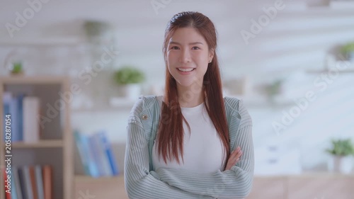 Beautiful asian business woman with crossed arms and smiling at camera. asia confident mature good looking young age leader female business woman on home office background.