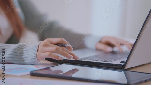 Close up of businessman hands typing on laptop keyboard at desk in minimal workspace. professional working on computer, entering text, managing information during daily business tasks at workplace.