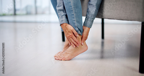 Fotografie Older Woman Soothes Sore Heel And Ankle