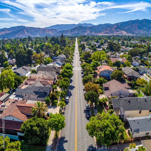 Aerial view of a suburban street with houses and trees