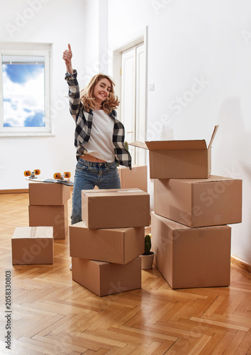 Excited woman celebrating successful move into new home