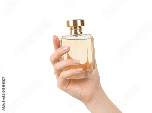 Woman holding a luxury glass perfume bottle with golden liquid in her hand isolated on transparent background