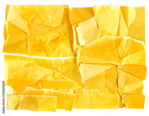 A collage of torn and crumpled yellow paper pieces on white background