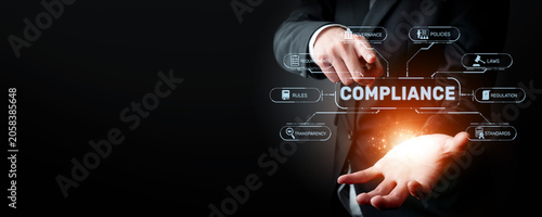 Photography A businessman illustrates key compliance concepts using digital graphics
