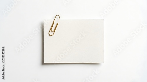 Blank White Rectangular Paper Note Attached with a Gold Metallic Paperclip on White Background