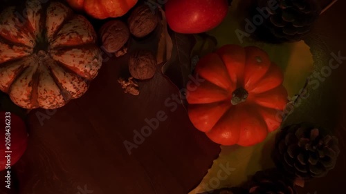 Detailed display of seasonal autumn produce items. Intimate perspective on harvest fruits and decorative gourds. Close inspection of autumnal harvest with mini pumpkins and mixed nuts on display