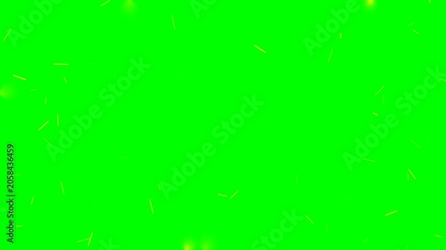Glowing yellow fire particles floating against a green background screen