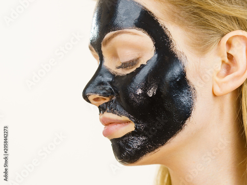 Girl black carbo peel off mask on face