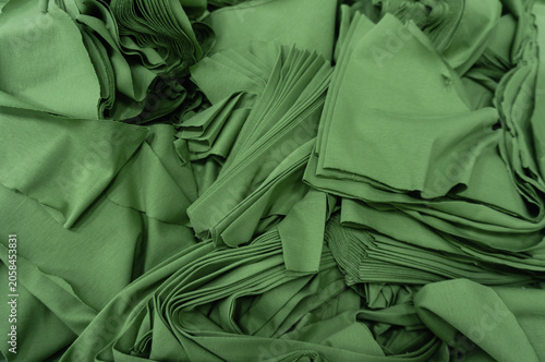 Stacked Olive Green Textile Fabric Material Layers for Industrial Apparel Manufacturing and Fashion Textile Background Design