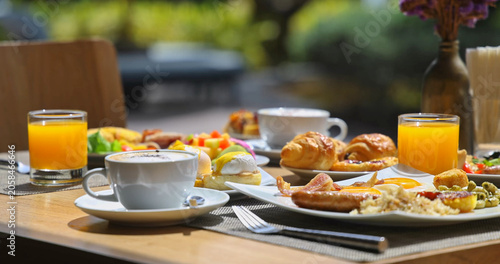 Photos Gourmet breakfast spread sitting on wooden table at outdoor restaurant terrace,