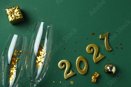 Photography Golden numbers 2027 with festive decorations, including gift box, champagne glasses, stars and ornaments, preparation for the New Year's celebration