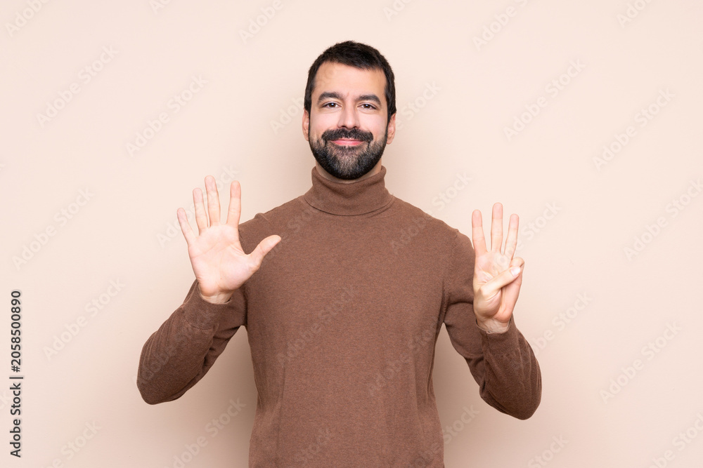Fototapeta premium Man over isolated background counting eight with fingers