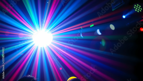Light show fills the room with colors as people enjoy music during a lively night at the club