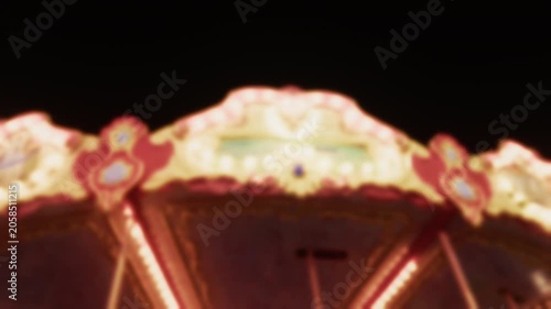 Blurred Carnival Lights With Colorful Bokeh At Amusement Park At Night