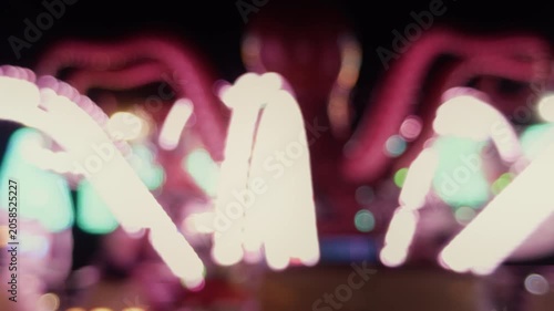 Blurred Carnival Lights With Colorful Bokeh At Amusement Park At Night
