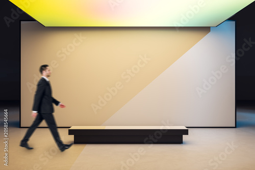 Minimalist exhibition hall with large blank geometric wall, soft gradient lig...