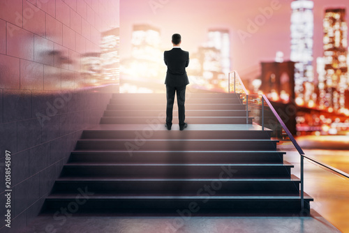 Obraz na plátne Business figure atop lit staircase facing glowing city skyline symbolizing success growth and elevate concept in abstract setting