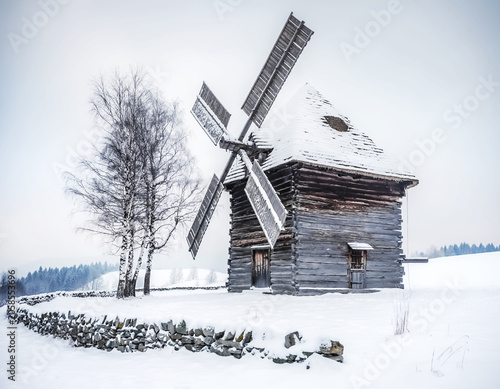 Old Slovak windmill with a thatched roof from the old days in winter